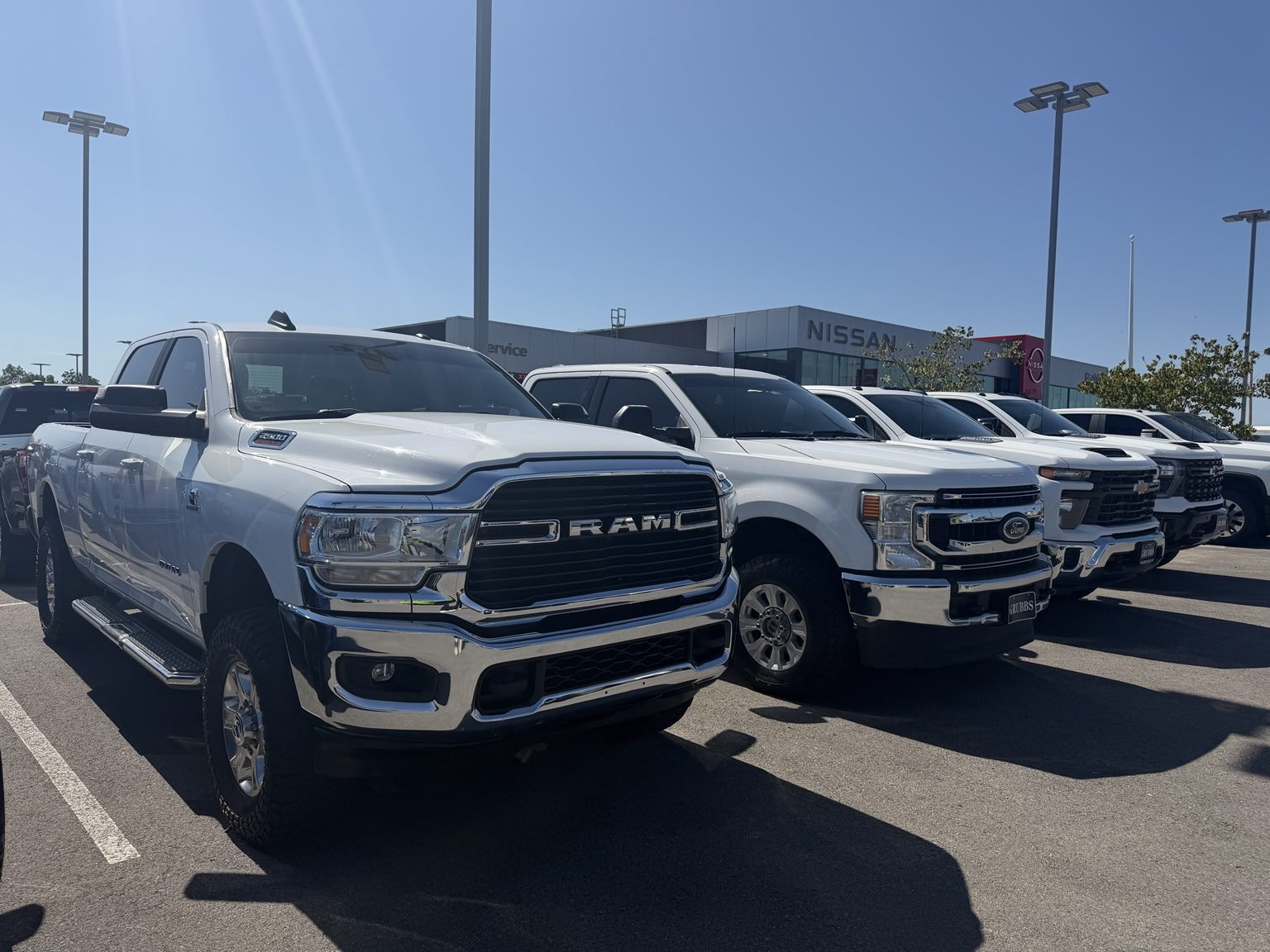 Pickup trucks with the Nissan dealership in the background